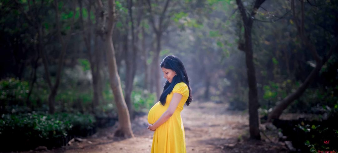 Rajani Looking at her baby bump in  maternity photoshoot in Pune, India