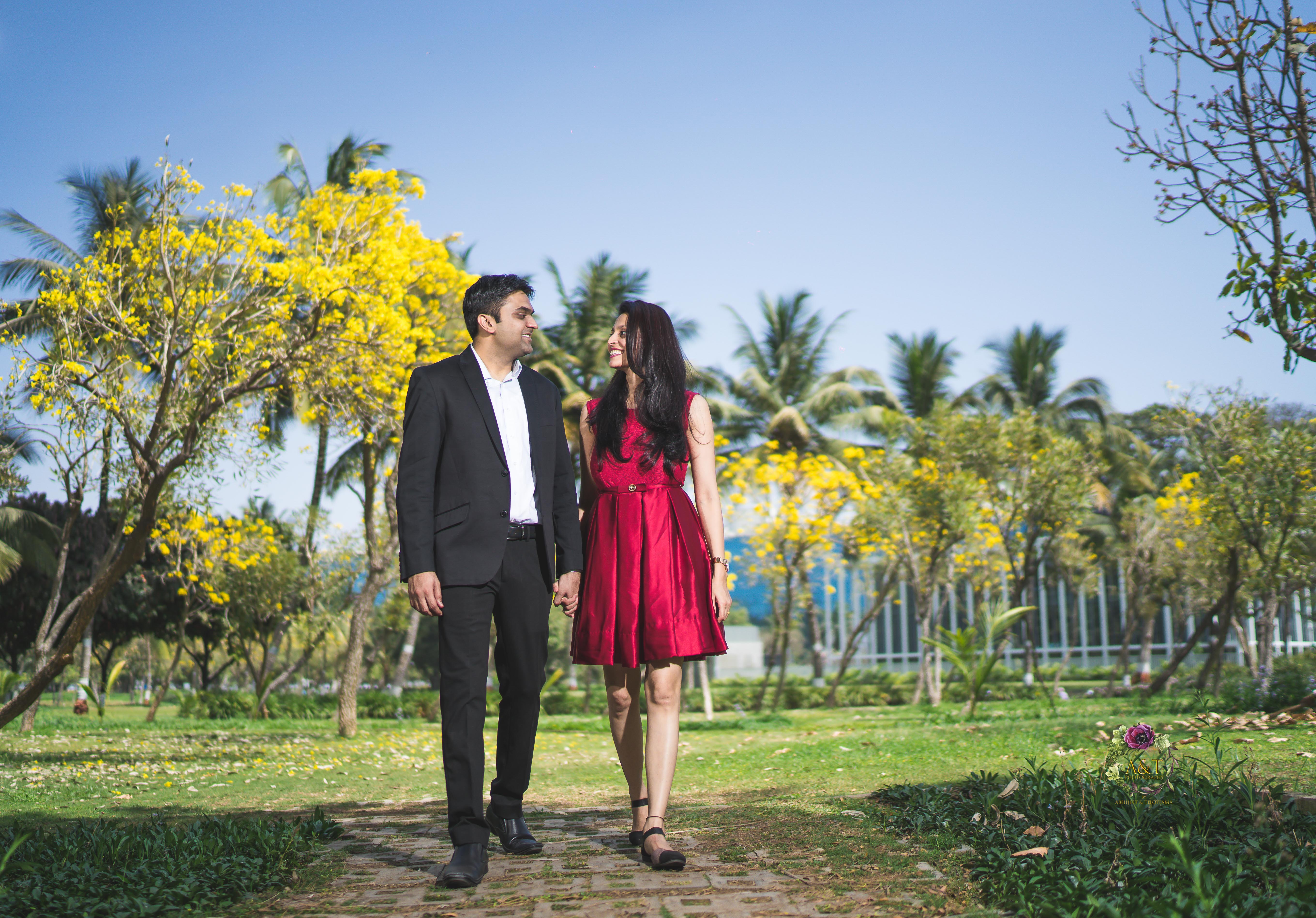 Priyanka & Swijal walking on beautiful pathway surrounded by yellow trees for their pre-wedding photoshoot in pune
