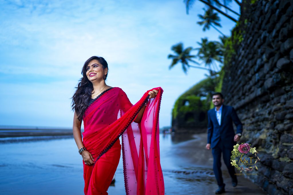 Cultural elegance meets beach beauty - The bride in an exquisite saree and the groom in formal wear. Image by top pre-wedding photographer in Pune