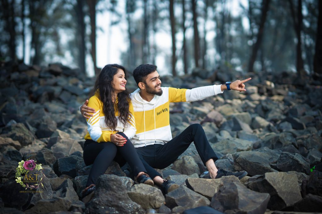 Happy candid moments of couple on beach captured by pre-wedding photographer in Pune