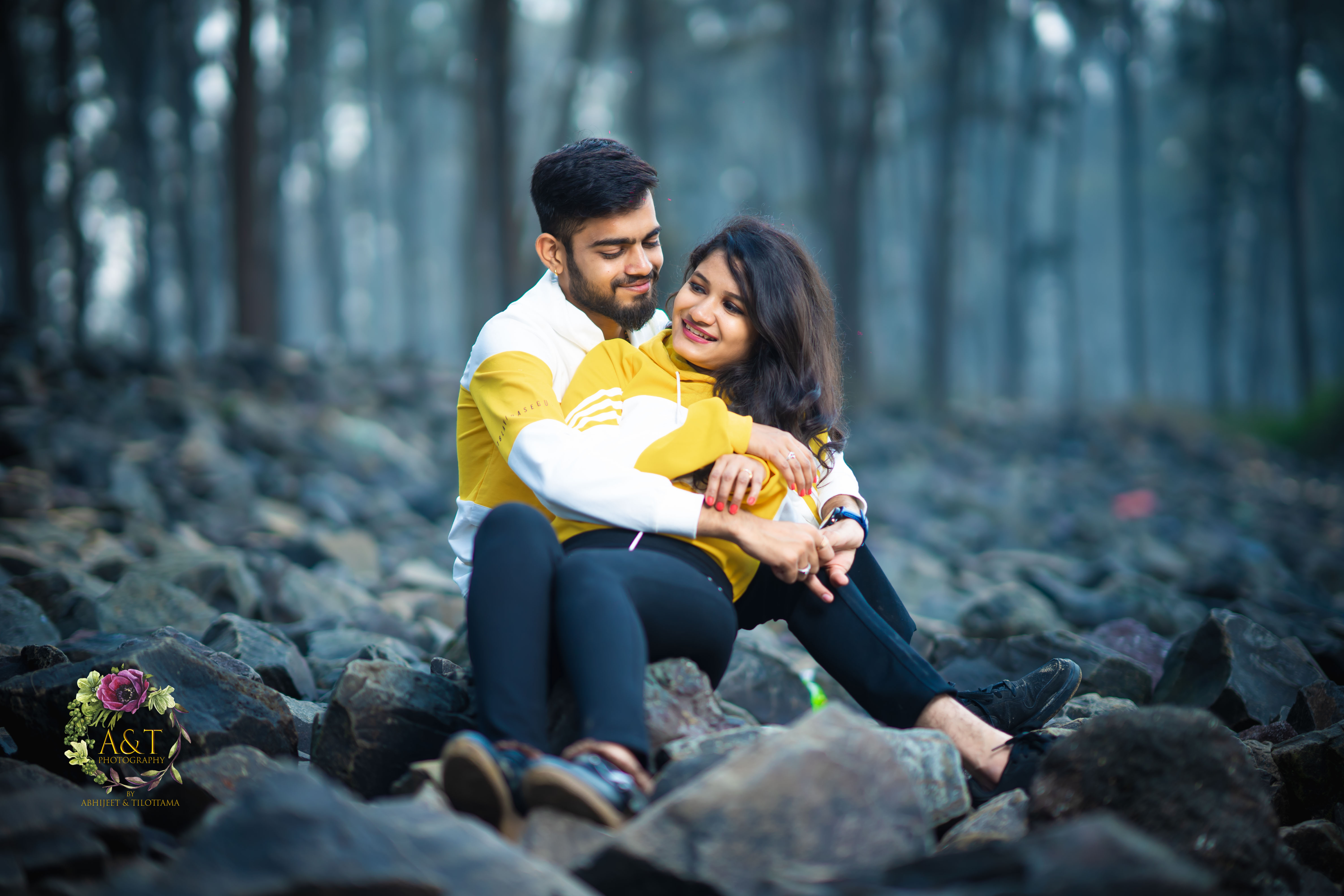 Dharmik and Jinal sitting on rocks at beach for their Best Pre-wedding Photoshoot 