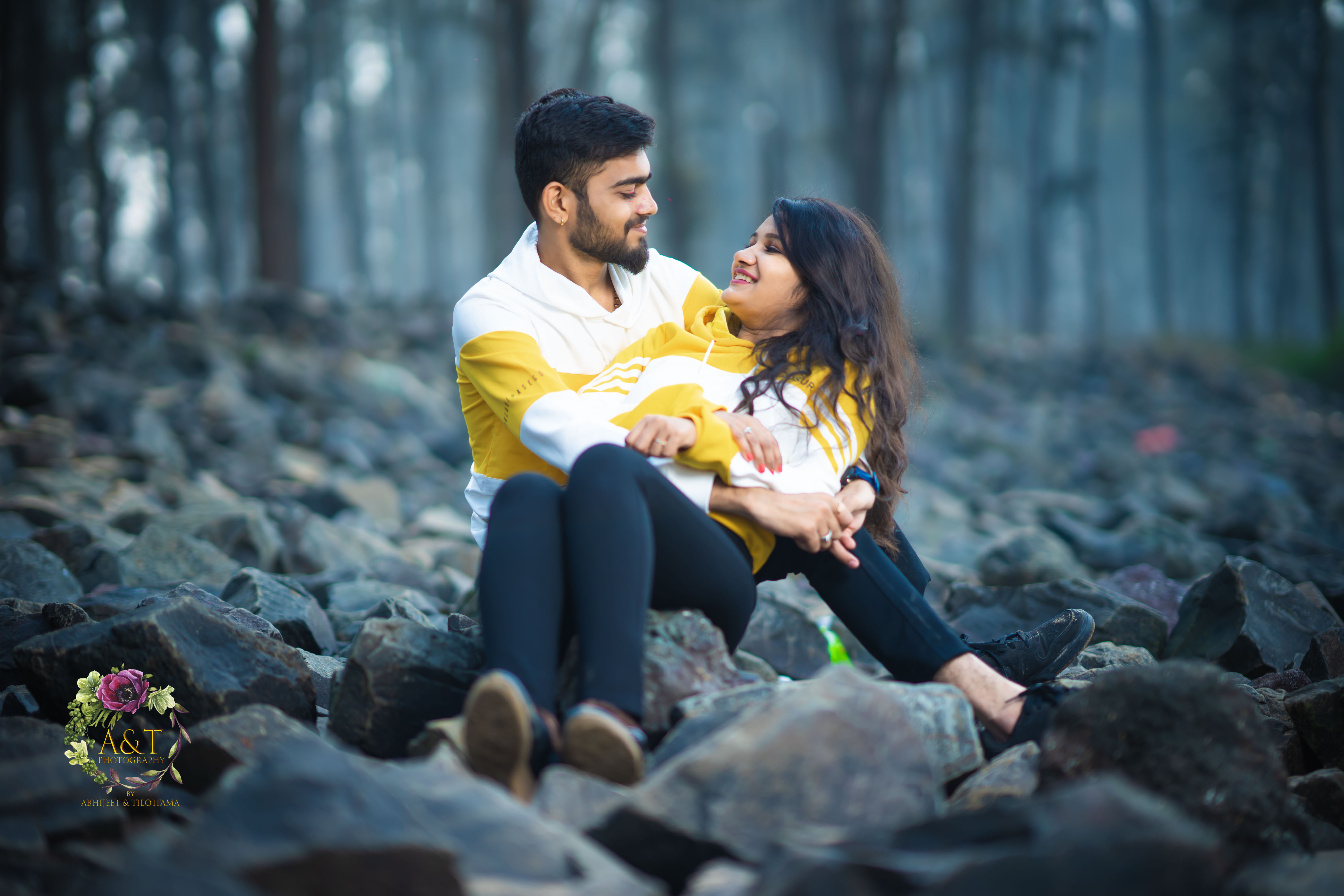 Picture of Couple Sitting on Rocks near beach for their pre-wedding photoshoot