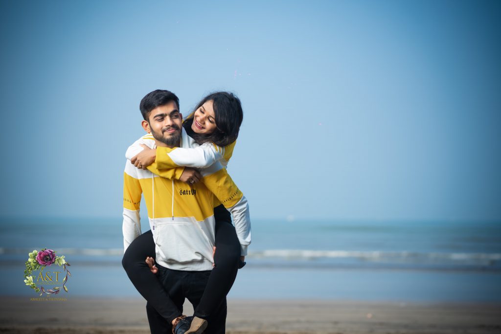 Romance under the sun - Couple sharing a tender moment at tranquil beach. Image captured by best pre-wedding photographer in Pune